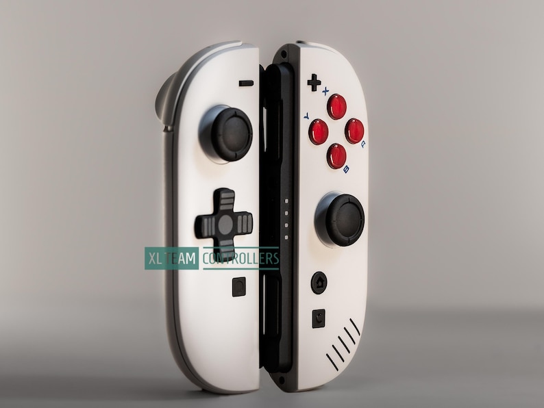 Custom-painted Nintendo Switch Joy-Cons in a nostalgic Game Boy retro theme. Features a classic off-grey matte shell with signature red ABXY buttons and a retro-style D-pad. Detailed black speaker-vent graphics on the right controller. Professional hand-painted automotive-grade matte finish for a high-end, smooth tactile feel.