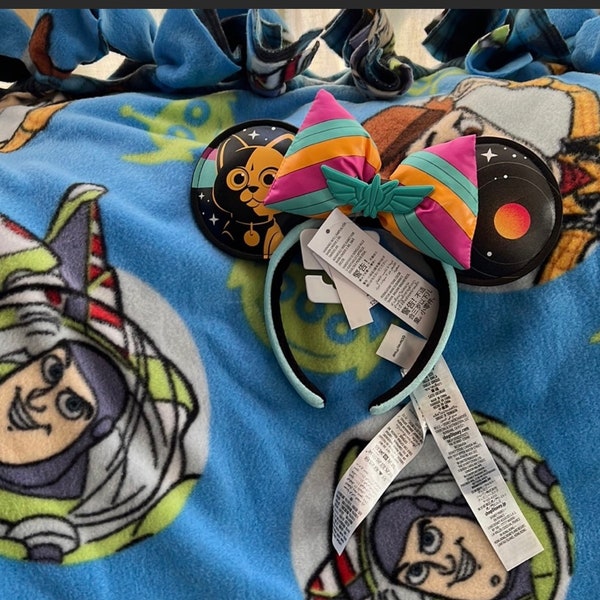 Toy Story, Buzz Lightyear fleece blanket with Disney Parks 2022 Buzz Lightyear headband ears.