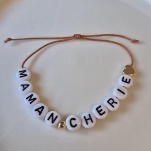 Pulsera MENSAJE personalizada en hilo de jade con bolita de corazón bañada en oro de 24 quilates. Infinitas posibilidades para un regalo único.