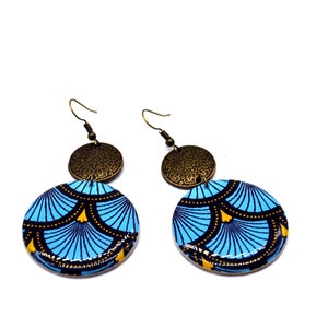 May include: A pair of blue and gold earrings with a geometric pattern. The earrings are made of wood and have a brass accent.