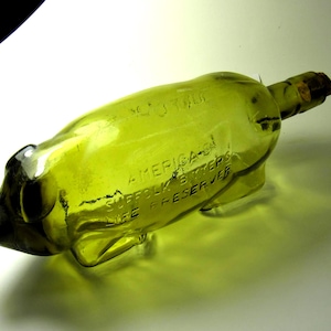 Antique Suffolk Bitters Pig Bottle – America&#39;s Life Preserver – Figural Yellow-Green Glass – 1890s