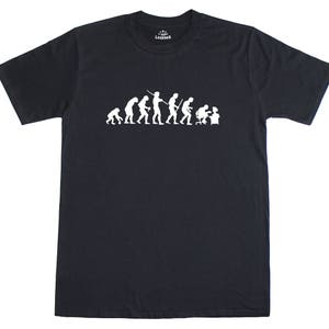 May include: A black t-shirt with a white graphic of the evolution of man, ending with a man sitting at a computer. The graphic includes the text "T-Shirt Legends".