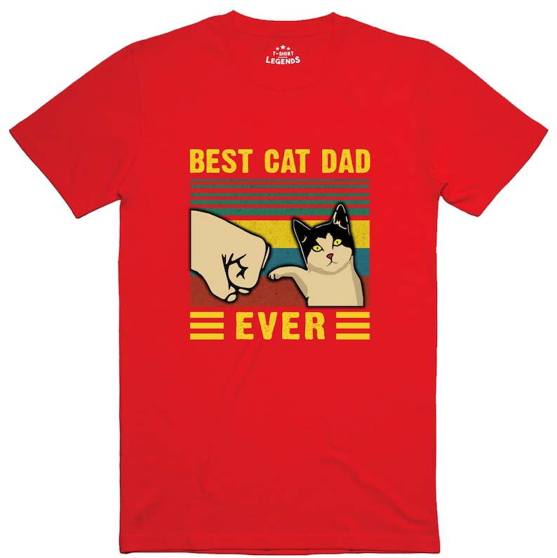 May include: Red t-shirt with a retro-style graphic that says "Best Cat Dad Ever" with a cat giving a fist bump.
