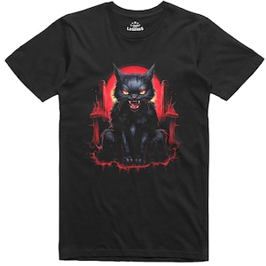 May include: Black t-shirt with a graphic of a black cat with glowing yellow eyes and a red background. The cat is sitting in a throne-like structure with flames on the sides. The text "T-Shirt Legends" is printed on the shirt.