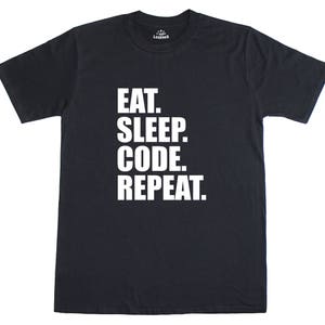 Op de afbeelding: Zwart T-shirt met witte tekst die "Eat. Sleep. Code. Repeat." luidt.