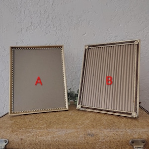 May include: Two rectangular picture frames labeled A and B. Frame A is gold with a scalloped inner border and a plain backing. Frame B is dark brown with a ribbed texture, gold corner accents, and a corrugated backing. Both are upright.