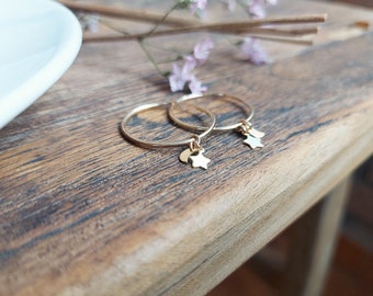 SPICA. 14k gold filled hoop earrings with moon and star shaped pendants.