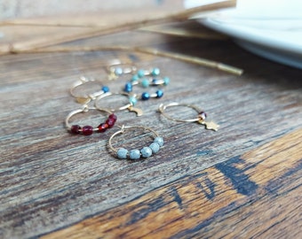 POLARIS. Asymmetric hoop earrings with faceted bohemian glass beads and star-shaped pendant