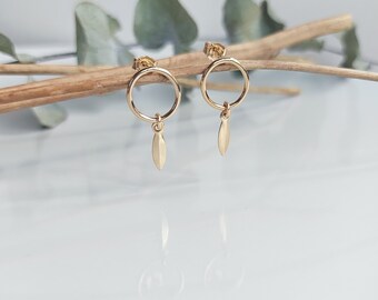 SAGITTA. 14k gold filled openwork circle earrings with arrow-shaped charms