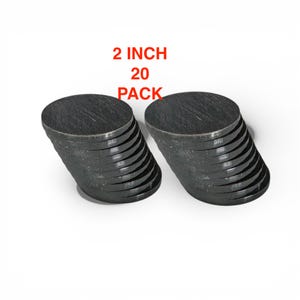 May include: Two stacks of dark gray, 2-inch diameter, circular wooden discs. The text "2 INCH 20 PACK" is in red above the discs. The discs are stacked in two separate piles.