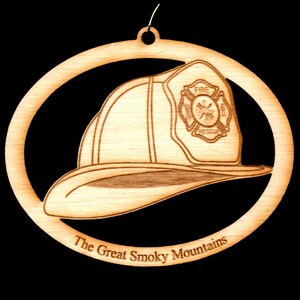 May include: A wooden ornament shaped like a firefighter's helmet with a red and white "Fire Rescue" emblem. The ornament is inscribed with "The Great Smoky Mountains".