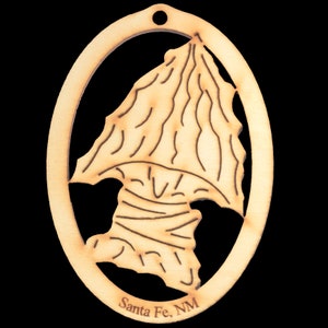 May include: Wooden ornament shaped like a stylized arrowhead with the text "Santa Fe, NM" at the bottom.