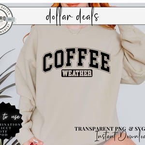 May include: A beige sweatshirt with the text "COFFEE WEATHER" in black block letters. The sweatshirt is being modeled by a person.