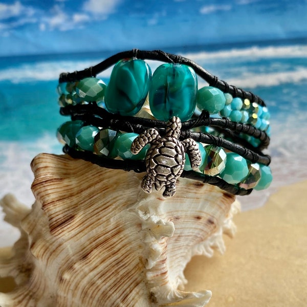 Double wrap, bead-weaved Sea Turtle bracelet in Czech crystal beads, teal colored 6mm bead, on black leather with Sandollar button