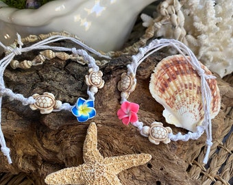 Surf Buddies Anklet/bracelet.  Pair of Sea turtles and a pink or blue plumeria adorn this Boho friendship Bracelet or Anklet on white cord