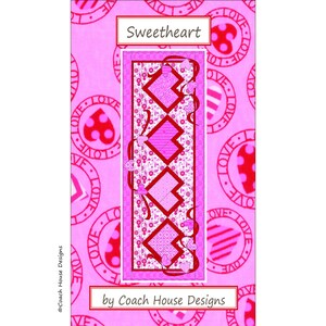 May include: A pink and red quilt pattern with a diamond design and the text "Sweetheart by Coach House Designs".