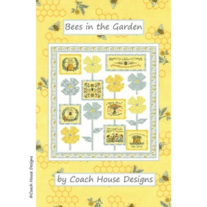 May include: A quilt pattern featuring a yellow and white background with a honeycomb pattern. The center of the quilt features a white square with a floral design and bee-themed text. The text reads "Bees in the Garden" and "by Coach House Designs".