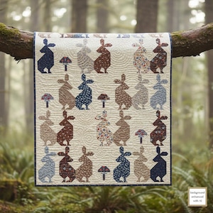 May include: A rectangular quilt featuring a repeating pattern of rabbits and mushrooms in various floral and solid fabrics. The cream-colored background has a wavy quilted texture, and the entire piece is finished with a dark blue border.