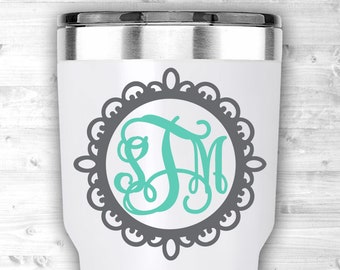 May include: White tumbler with a silver rim, featuring a gray decorative frame with a teal monogram. The monogram includes the letters S, J, and M in a stylish, cursive font. The tumbler is designed for beverages.
