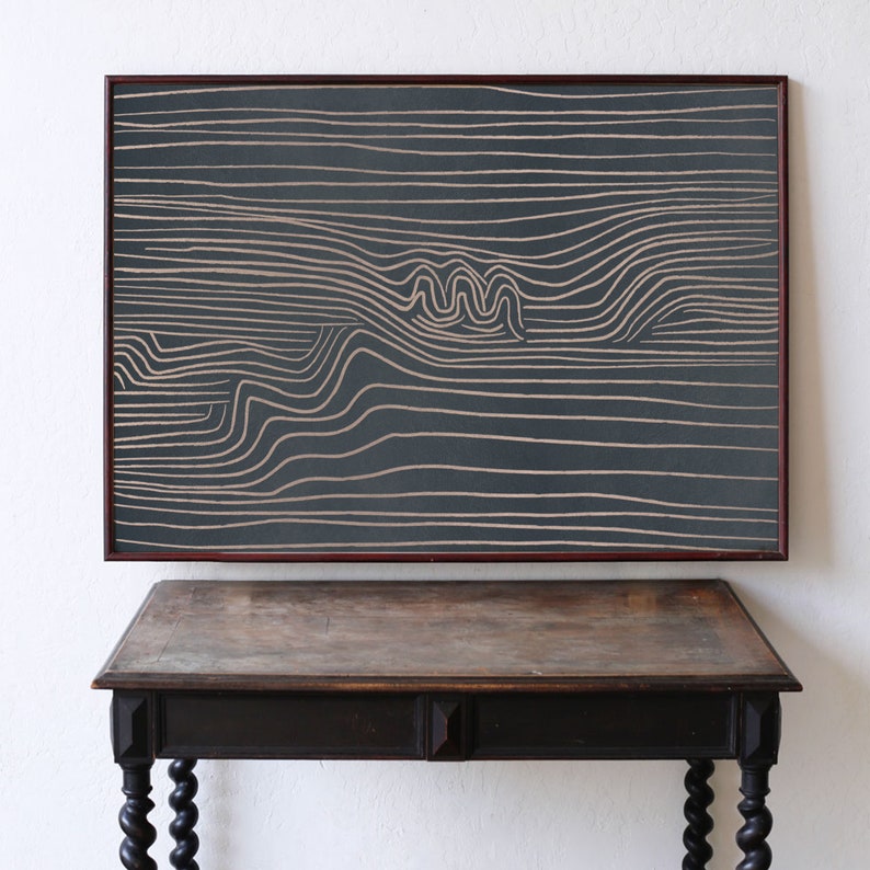 May include: A framed abstract art print with a dark gray background and white lines creating a wavy pattern.