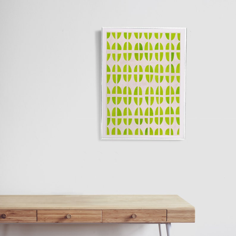 May include: A framed abstract print with a geometric pattern of green circles and white lines on a light pink background.