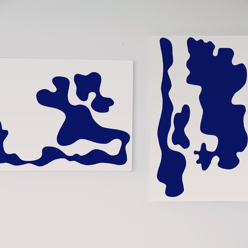 May include: Two abstract art prints with a white background and blue abstract shapes. The shapes are organic and resemble islands or clouds.