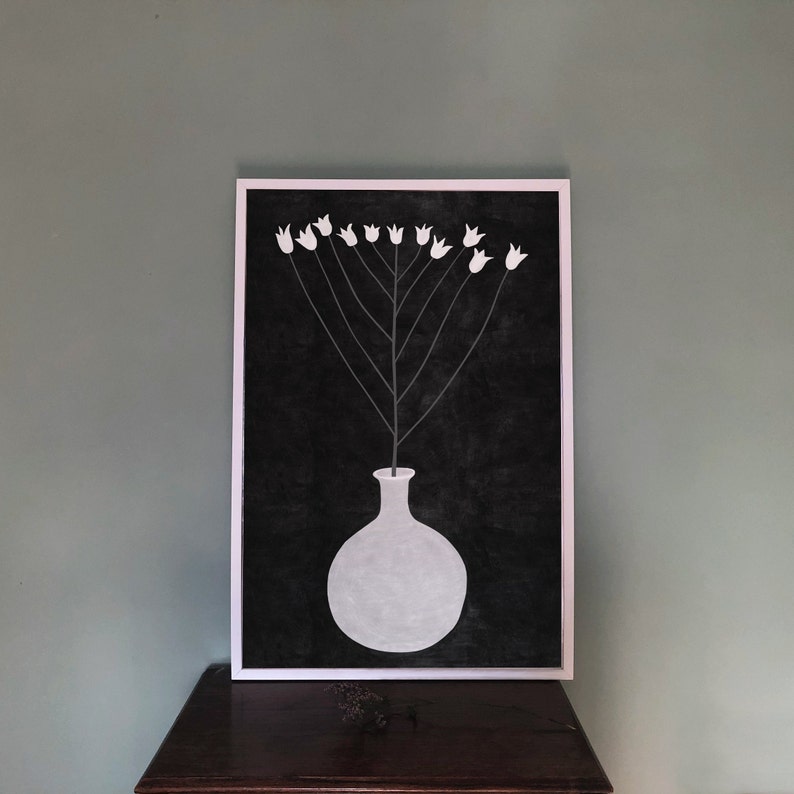 May include: A black and white illustration of a vase with white flowers on a black background. The vase is round and has a short neck. The flowers are simple and stylized.