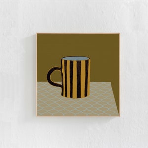 May include: A striped mug with black and yellow stripes sits on a patterned tablecloth. The mug is filled with a light blue liquid.