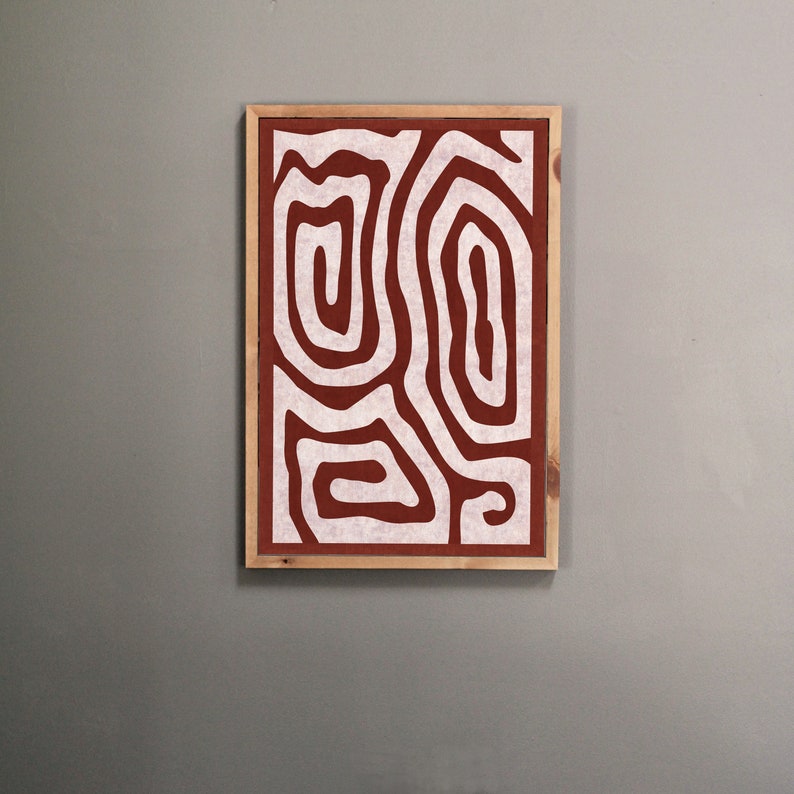 May include: A framed abstract print with a white design of swirling lines on a rust-colored background.