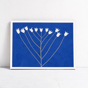 May include: A white silhouette of a stylized flower with multiple stems against a solid blue background. The flower is reminiscent of a menorah.