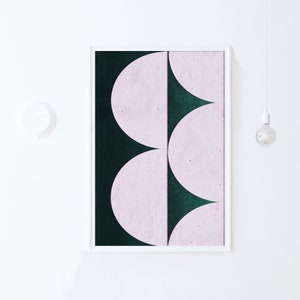 May include: A framed abstract art print with a green background and three pink semi-circles.