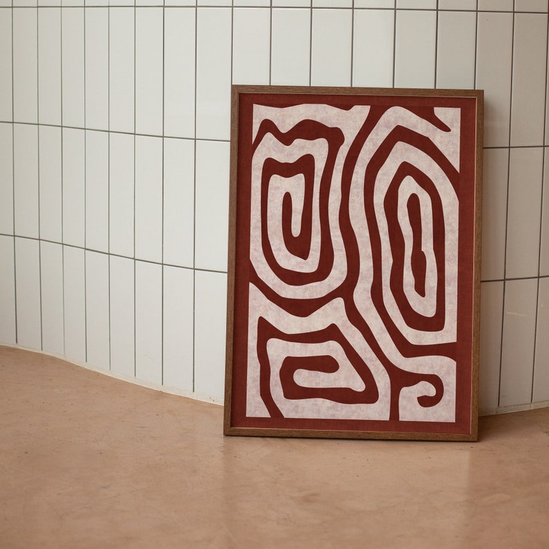 May include: A framed abstract print with a white design of swirling lines on a red background.