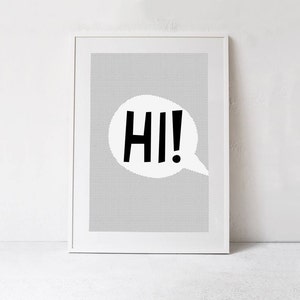 May include: A white framed print with a black and white polka dot background. A white speech bubble with the word "HI!" in black letters is in the center of the print.