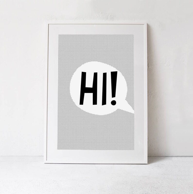 May include: A white framed print with a black and white polka dot background. A white speech bubble with the word "HI!" in black letters is in the center of the print.