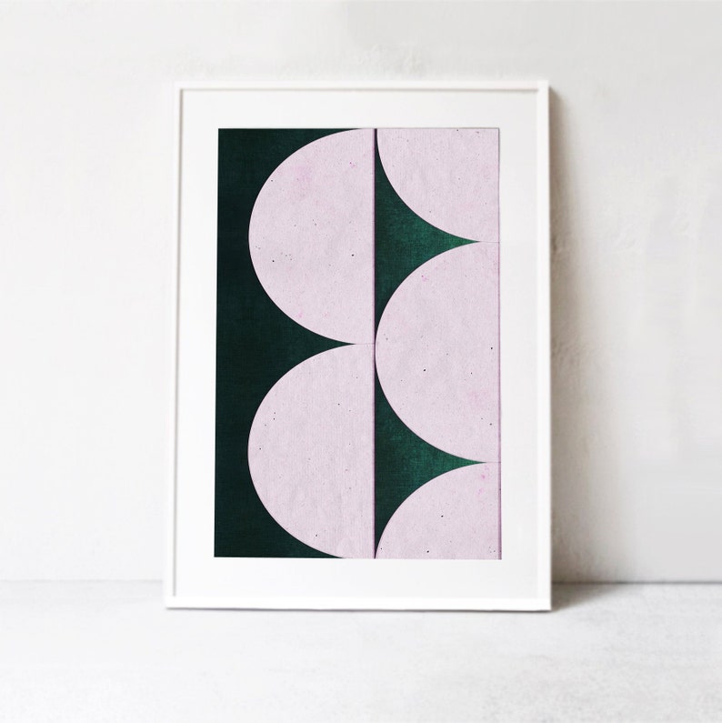 May include: Abstract art print featuring a geometric design of overlapping pink and dark green semi-circles.