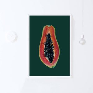 May include: A halved papaya with black seeds against a dark green background.