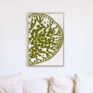 May include: A framed print of a green abstract design on a white background. The design resembles a stylized tree or coral with a cluster of circles in the center.