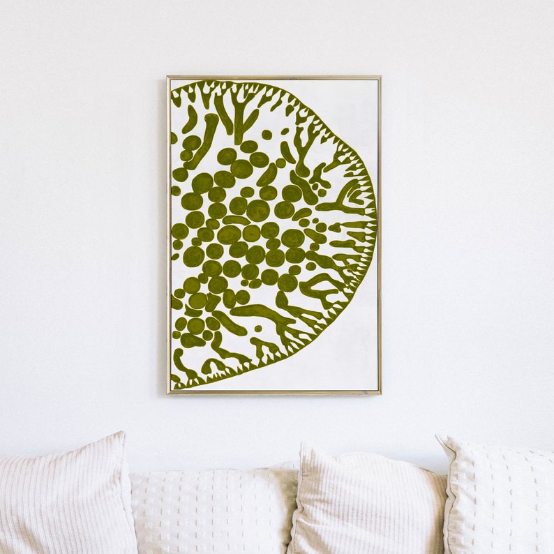 May include: A framed print of a green abstract design on a white background. The design resembles a stylized tree or coral with a cluster of circles in the center.