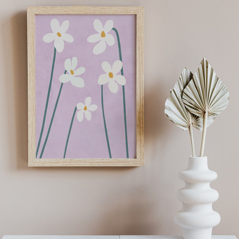 May include: A framed print with a minimalist design featuring five white flowers with yellow centers on a light purple background.