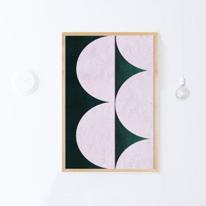 May include: A framed abstract art print with a geometric design of overlapping pink and green semi-circles.