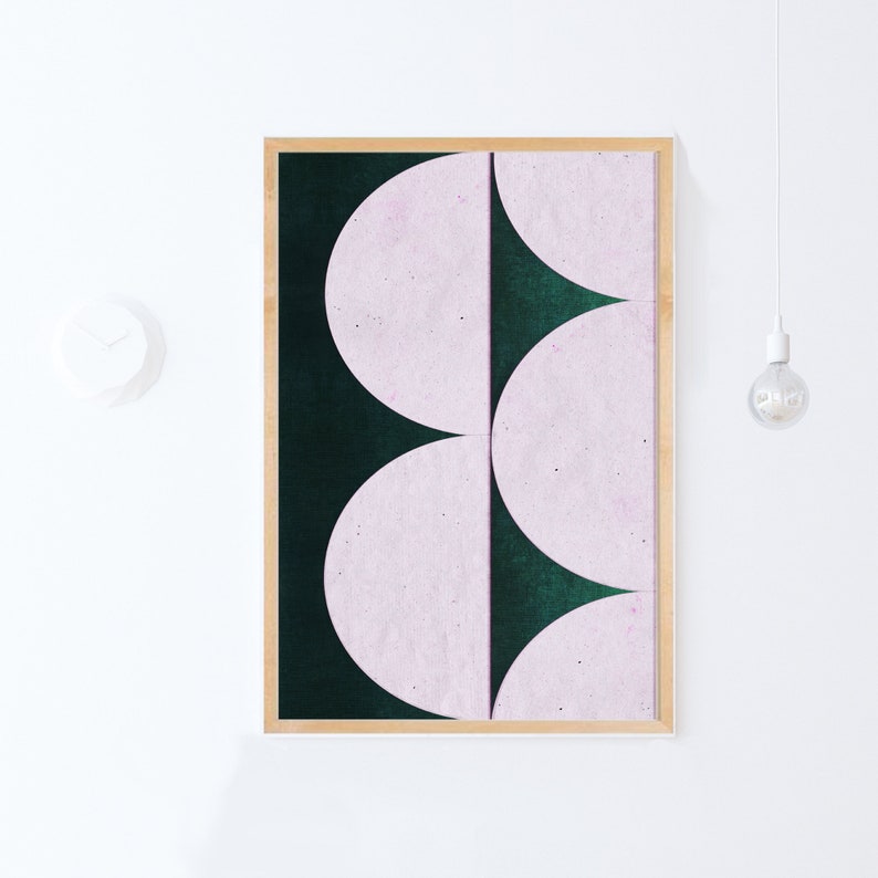 May include: A framed abstract art print with a geometric design of overlapping pink and green semi-circles.
