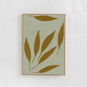 Può includere: Una stampa d'arte astratta incorniciata con uno sfondo verde chiaro e forme dorate simili a foglie.