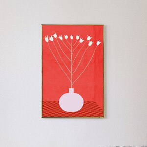 May include: A framed print of a white flower arrangement in a pink vase against a red background with a checkered pattern at the bottom.
