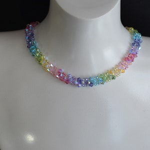 May include: A rainbow crystal necklace with iridescent beads. The necklace is made of small, faceted crystals in shades of red, orange, yellow, green, blue, indigo, and violet.