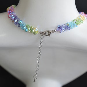 May include: A rainbow crystal necklace with a silver clasp and extender chain.