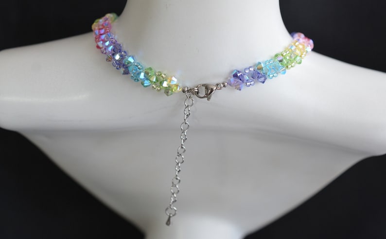 May include: A rainbow crystal necklace with a silver clasp and extender chain.