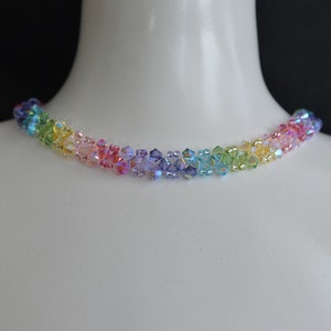May include: A rainbow crystal choker necklace with small, faceted beads in shades of red, orange, yellow, green, blue, indigo, and violet.