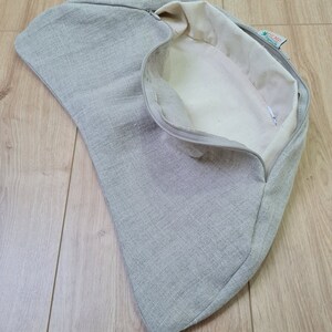 May include: A gray linen zippered pouch with a white interior and a green label that says "HEMP" with a green leaf logo.