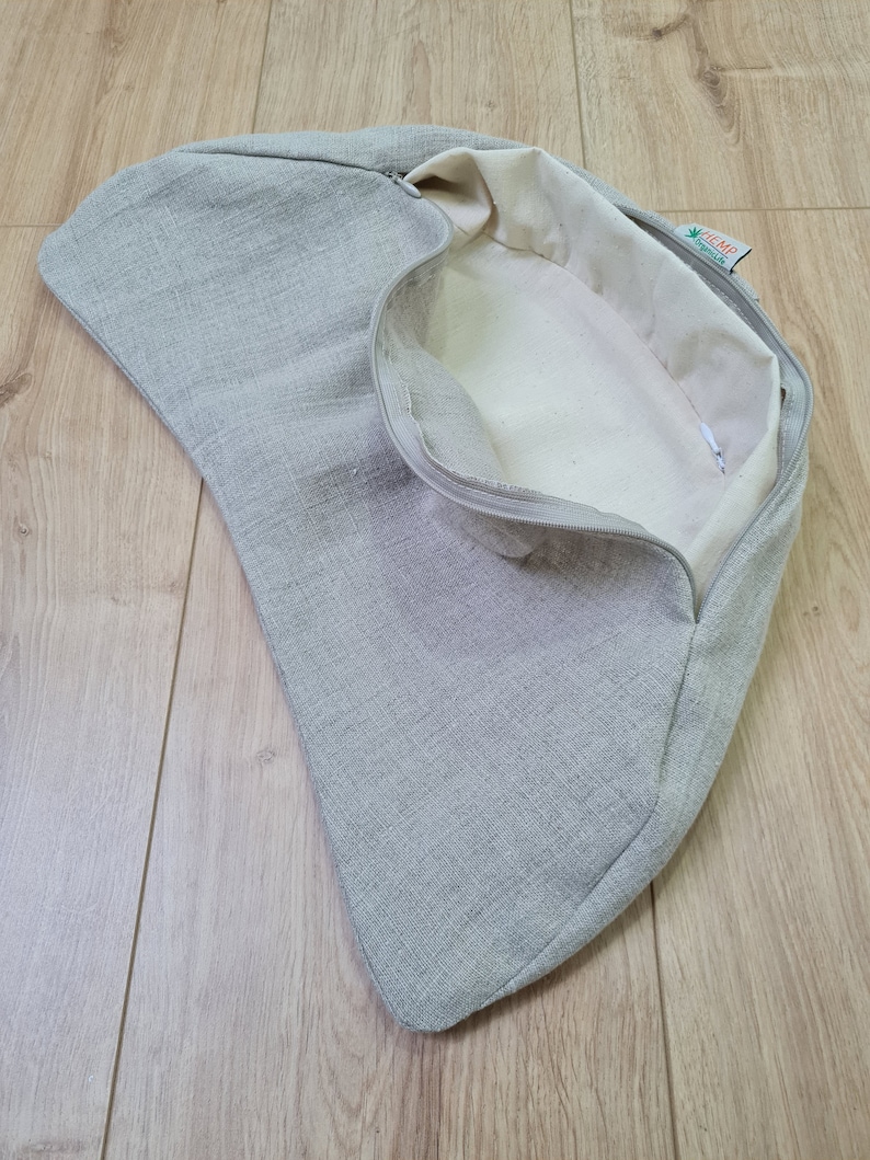 May include: A gray linen zippered pouch with a white interior and a green label that says "HEMP" with a green leaf logo.