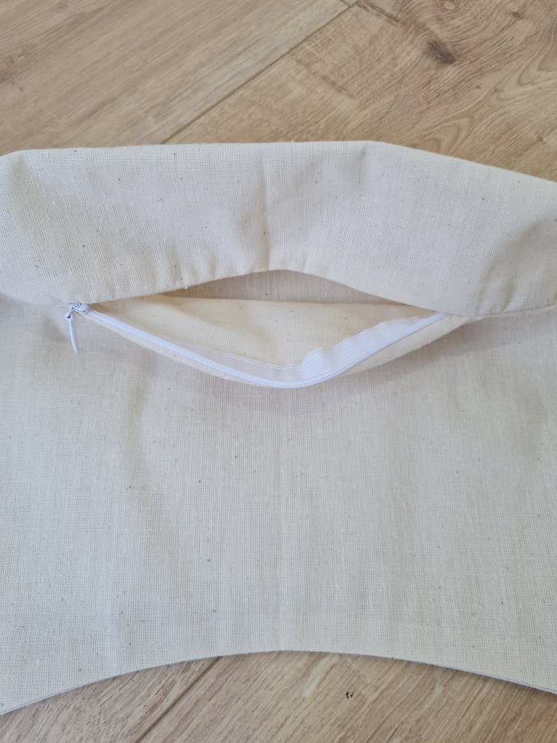 May include: A white cotton pillow cover with a zipper opening. The cover is made of a soft, natural fabric and has a subtle texture.